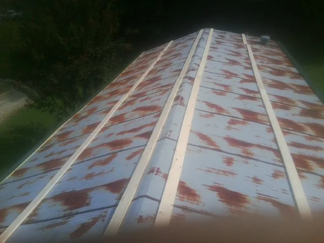 Rusted metal roof panels with new wood purlins before replacement — Storm Damage Roof Repair in Central Point by Roofing Brothers